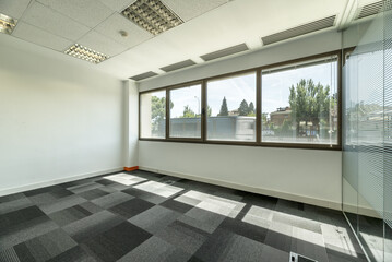 empty offices with separate offices with glass partitions, large windows