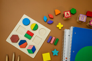 Fractions, rulers, pencils, notepad on brown background. Set of supplies for mathematics and for...