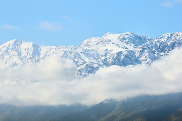 Fototapeta na wymiar Snowy mountain range with clouds