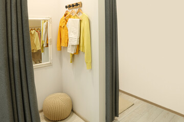 Dressing room with mirror in fashion store. Stylish design