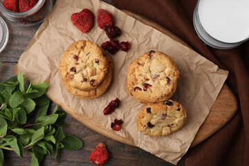 Cookies with freeze dried fruits and mint on wooden table, flat lay