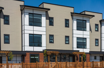 Facade of new residential townhouses. Apartment buildings in Canada. Modern complex of apartment buildings in spring