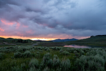 Sun Fades Behind Thick Clouds At Sunet In Hayden Valley