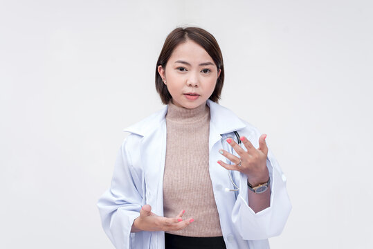 Portrait of a young and skilled doctor, medical student, intern, explaining something. Isolated on a white background.