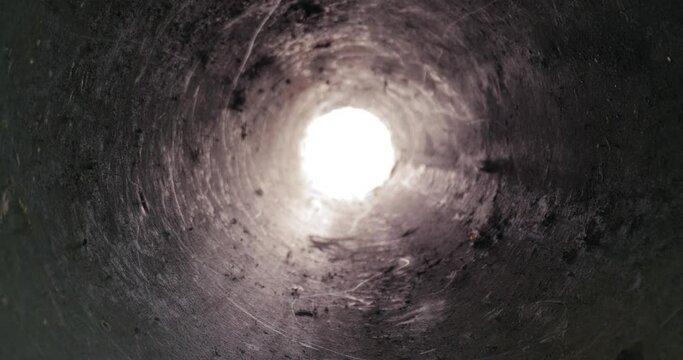 Dirty tube hole motion towards bright light source end of pipe