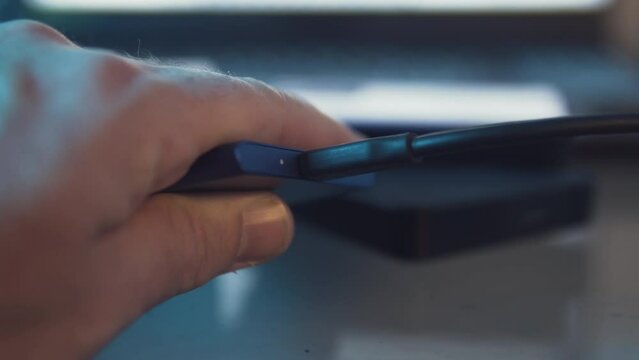 Close up plugging in a solid state recovery hard drive. Data Storage on an external disk. Copying and cloning an operative system from a computer.