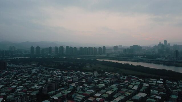 Cityscape Of Wanhua District In Smog Along Tamsui River In Taipei City, Taiwan. aerial tilt-up