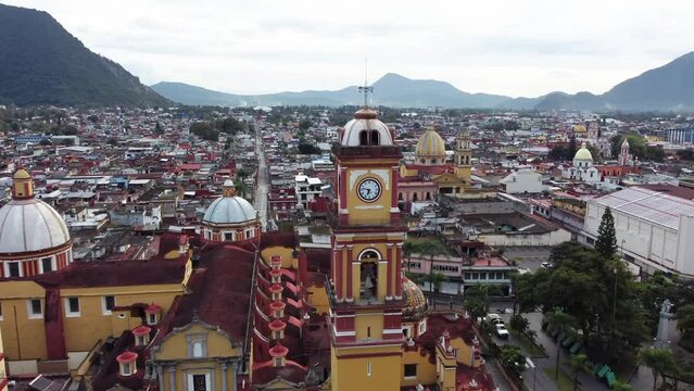 Approaching Cathedral of Orizaba clock tower with view of city and hills behind