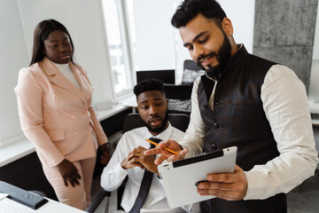 Young multiracial people in business suits working together at office