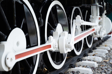 Side view of the lower shock The iron wheels of a steam locomotive on the tracks