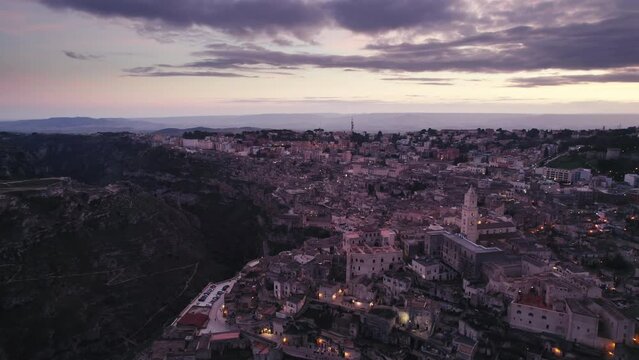 Magic hour sunset aerial over the Ancient Jerusalem looking city of Matera in Basilicata, Italy and its ravine