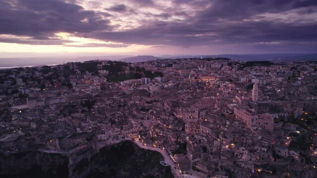 Magic hour sunset aerial over the Ancient Jerusalem looking city of Matera in Basilicata, Italy and its ravine