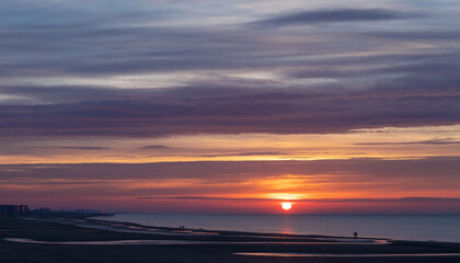 Fototapeta na wymiar North Sea beach sunset people silhouette of Oostende (Ostend) at sunset, Flanders, Belgium