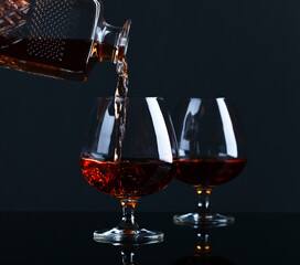 Obraz na płótnie Canvas Snifter with brandy on a black background