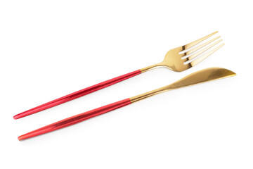 Golden fork and knife with red handles on white background