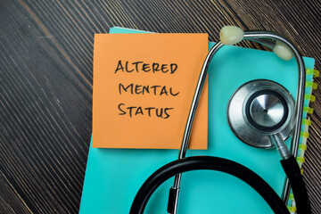 Concept of Altered Mental Status write on sticky notes with stethoscope isolated on Wooden Table.