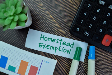 Concept of Homestead Exemption write on sticky notes isolated on Wooden Table.