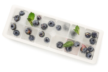 Ice tray with fresh blueberry frozen in ice on white background