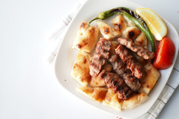 Kebab, traditional turkish meat food with salad on a plate 