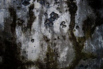 This close-up of a weathered, rundown wall displays the deterioration of its textured pattern and...