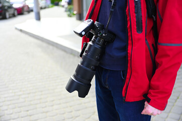 A photographer is seen capturing images in an urban setting, perhaps focusing on the unique...