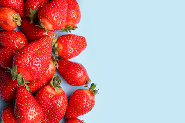 Fresh strawberries on blue background