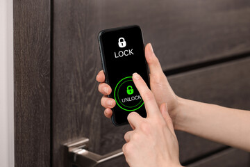 Woman unlocking door using mobile phone, closeup. Illustration of closed and open padlocks on...