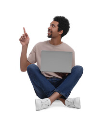 Smiling man with laptop pointing at something on white background
