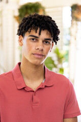 Portrait of happy biracial man with curly black hair at home