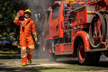 With a firm grip on the fire hose the firefighter displays a sense of readiness prepared to combat the flames and provide assistance to those in distress.