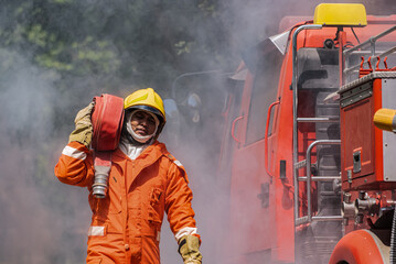 The firefighter's focused gaze and steady stance reflect their preparedness to swiftly respond to...