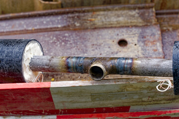 Close-up of pipe at repair site of district heating at City of Zürich district Schwamendingen on a rainy spring day. Photo taken May 11th, 2023, Zurich, Switzerland.