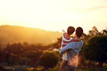 Father, child and pointing to sunset in nature for travel, holiday or weekend getaway outdoors....