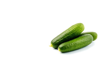 A pile of fresh green cucumbers isolated on white background with copy space. Created with Generative AI Technology