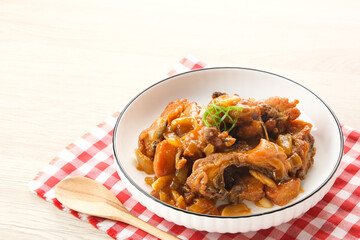 Ayam Goreng Mentega or Butter Chicken in white plate. Indonesian food.
