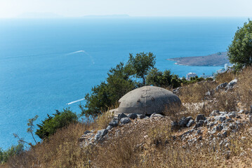 Surrounding Saranda, Albania, are hills topped with military bunkers guarding the high shore of the Ionian Sea - 602854357
