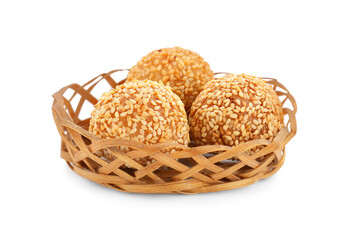 Wicker basket of delicious sesame balls on white background