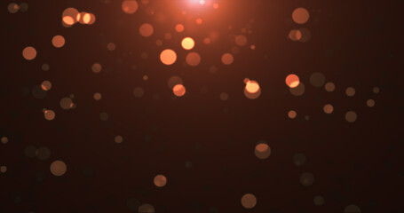 Abstract background of yellow orange gold glowing particles and bokeh dots of festive energy magic