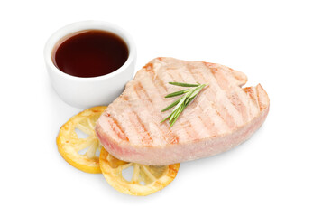 Delicious tuna steak with sauce, lemon and rosemary isolated on white