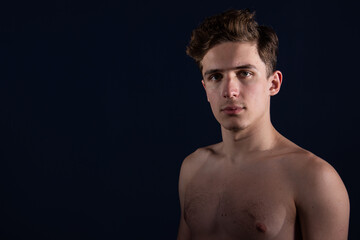 Fototapeta premium Young attractive man with athletic body posing in the studio.