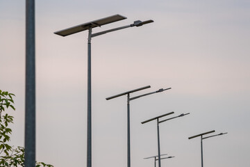 Street lights powered by solar panels. Sustainable energy. Green energy lighting.