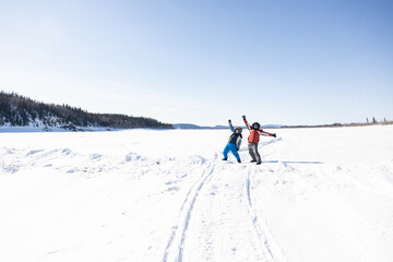 Fototapeta na wymiar Two happy people on the frozen Yukon River in Alaska