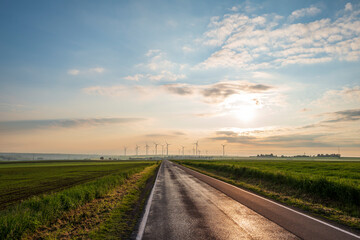 Obraz na płótnie Canvas road to the sky with wind turbines