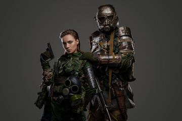 Fototapeta na wymiar Shot of post apocalyptic people dressed in camouflage uniform against gray background.