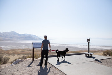 Young woman and black dog at the top of Buffalo Point in Utah