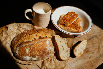 Whole wheat bread, milk and pastries on the table