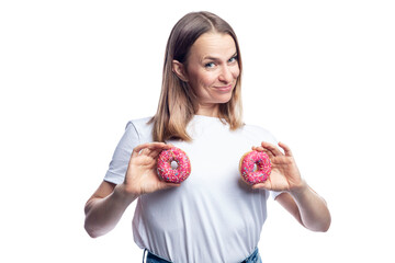 Joyful woman in a white t-shirt with donuts with icing in her hands. Health and delicious junk food. Isolated on white background. Space for text.