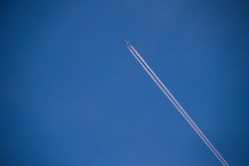 Plane Flying Overhead with Contrails at Sunset