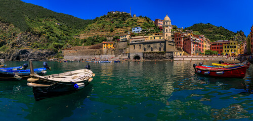 Mediterranean Sea with colorful boats and houses in Vernazza, Cinque Terre Italy