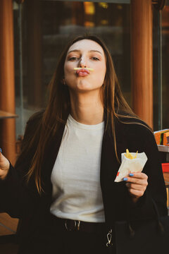 The white beautiful girl going crazy with a fries close up